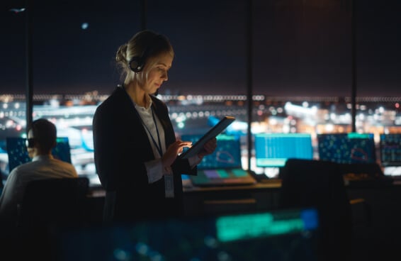 Female Air Traffic Controller Working on Tablet in Airport Tower