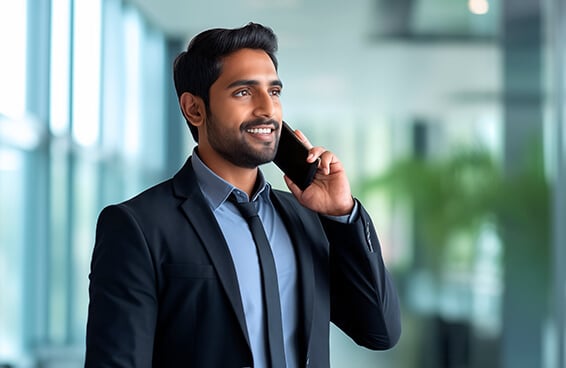 A man in a suit engaged in a conversation on his cell phone