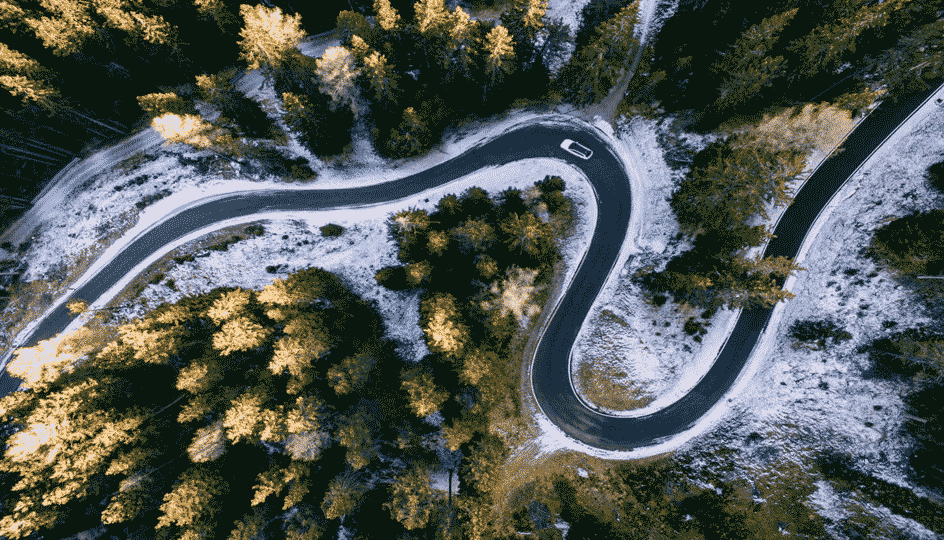Snowy forest with a road