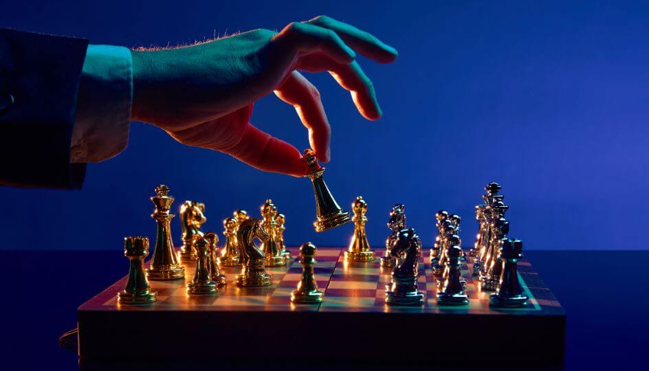 A person moving a chess piece